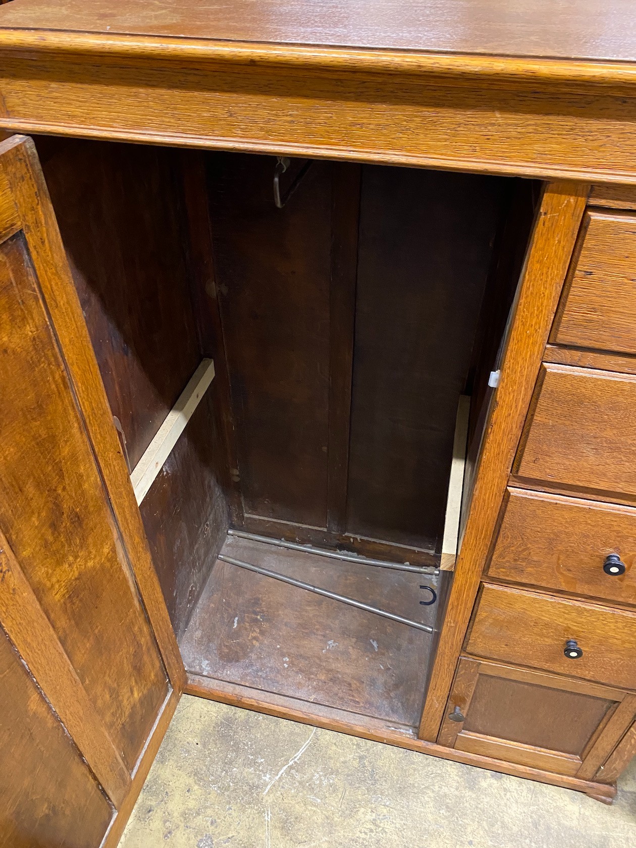 An early 20th century 'S.B.S.' furniture oak compactum with hinged mirrored top, width 102cm, depth 47cm, height 138cm
